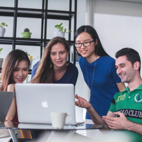 Group of young people looking at computer screen